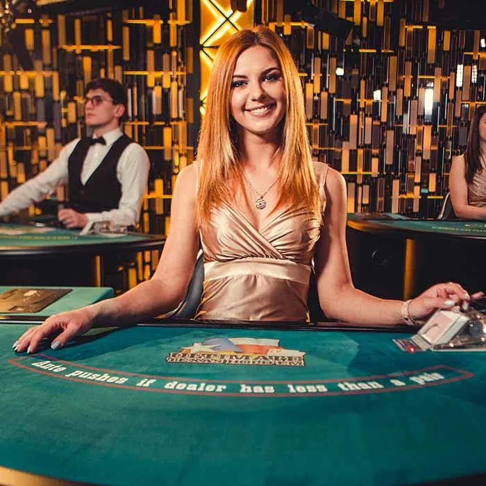 Live blackjack dealer at a licensed studio table