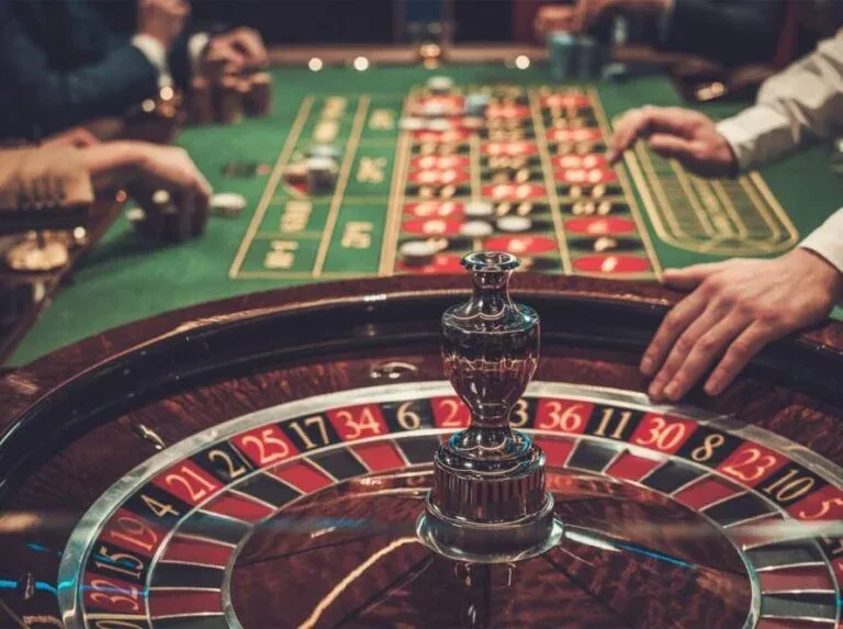Live roulette wheel with players placing chips